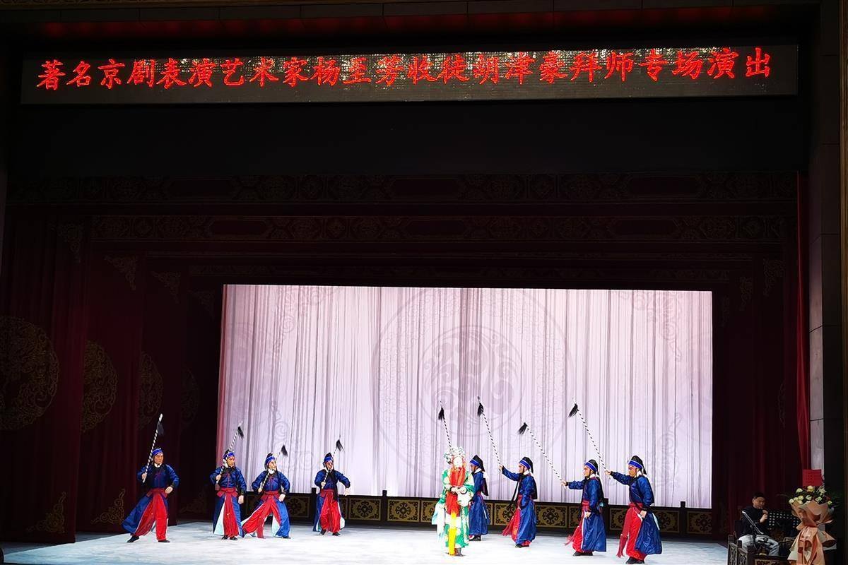 名家杨至芳收徒专场惠民演出舞台全景,背景LED横幅作「著名京剧表演艺术家杨至芳收徒胡津豪拜师专场演出」