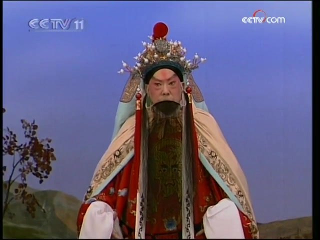 央视《名段欣赏》所播京剧《沙桥饯别》选段录像截帧:汪正华演唱(王帽红蟒、黑三髯老生扮相)